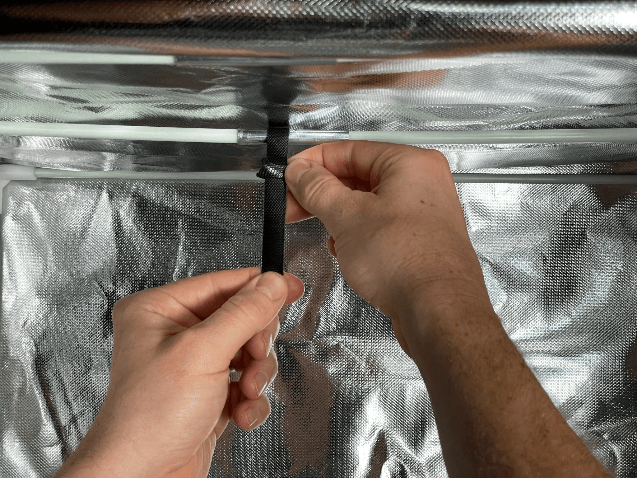 7 Attach the strap to the crossbar